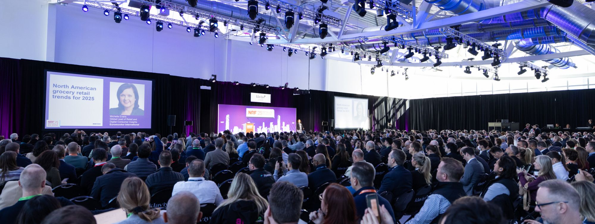 Large audience attending a stage conference at the NRF event.