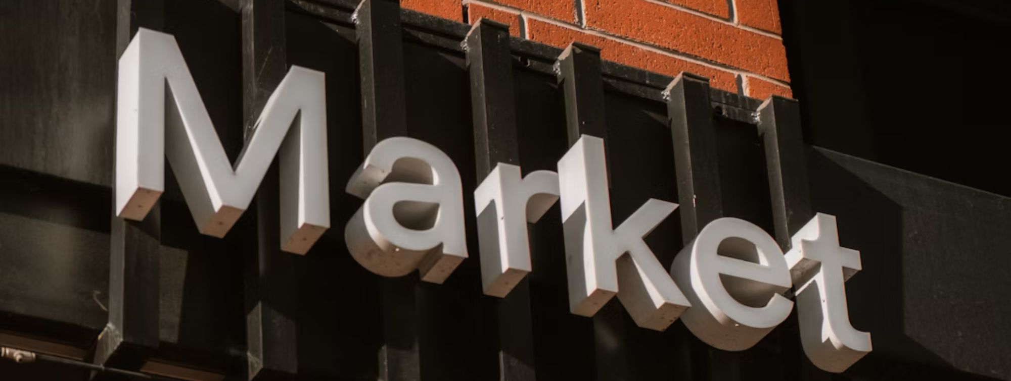 "Market" sign on a red brick storefront