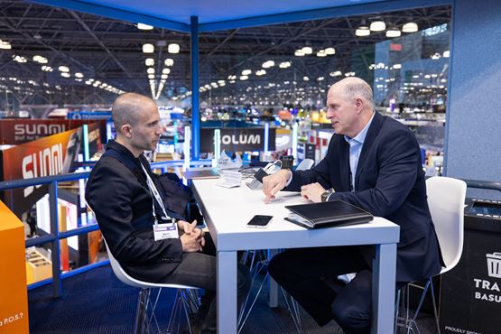 A business conversation between two professionals during the show.